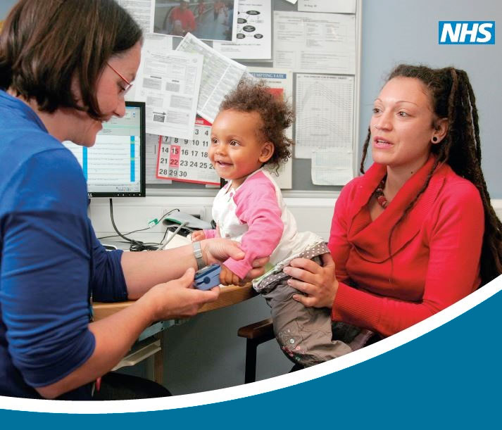 Doctor examining a small child who is being held by her mother