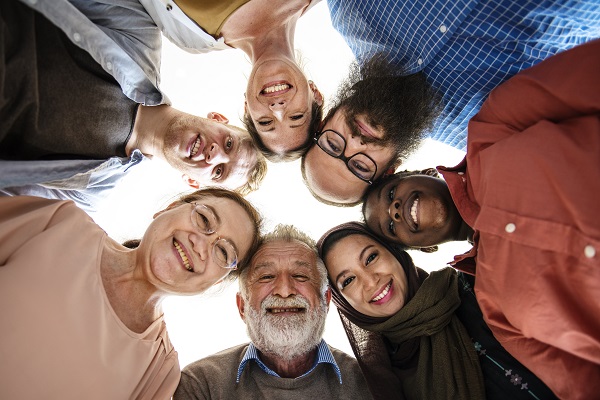 Group of people looking down at the camera and smiling