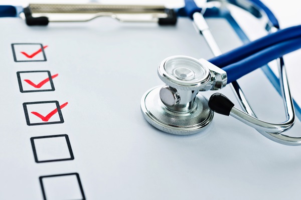 Stethoscope on a clipboard with boxes ticked