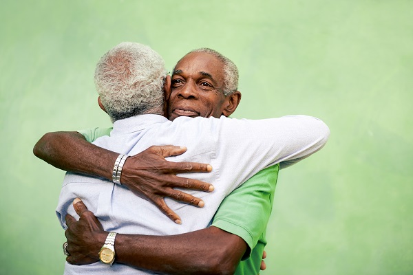 2 older men hugging
